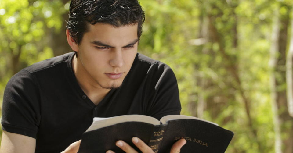Young man reading the Bible.